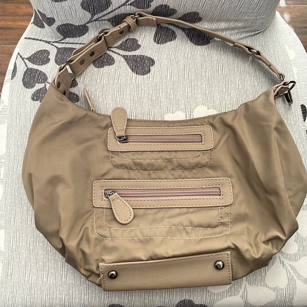 Sondra Robert’s crescent shaped bag. Tan color many pockets. Material washable